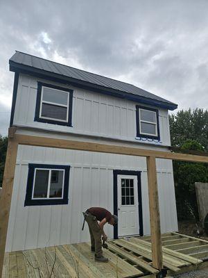 Carpenter laying down the deck entrance is all painted