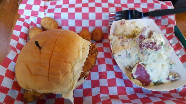 Purist chicken sandwich with Potato salad and hush puppies.