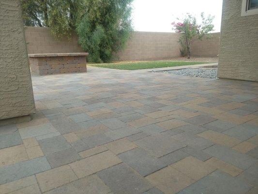 Pavers on patio as well as a fire pit and artificial grass