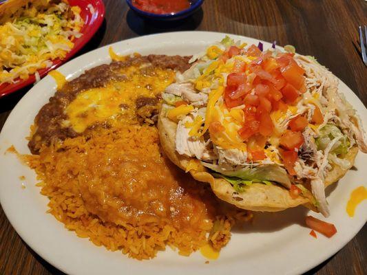 Combination plate with chicken tostada and taco (on other plate).