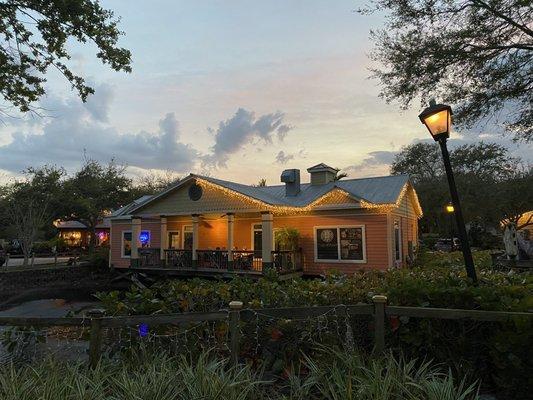 The back of the restaurant with outdoor seating on the pond.