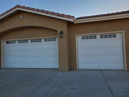 Garage doors look new again now that the trim has been sanded and repainted around the doors