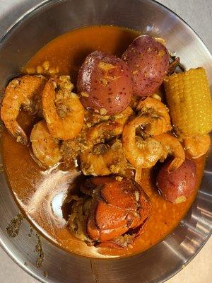 Shrimp, lobster tail, corn, and potatoes