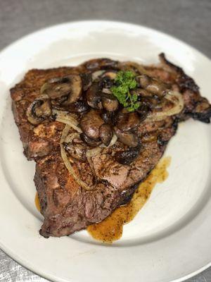 Porterhouse steak with sautéed mushrooms and onions