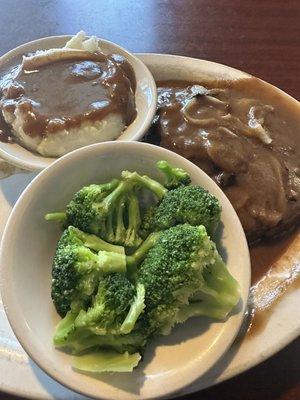 Salisbury steak, mashed potatoes with gravy, and steamed broccoli