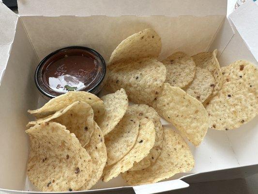 Side of chips and salsa served with the tacos. [GF]