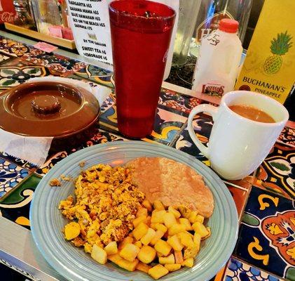 Scrambled eggs with chorizo, refried beans, fresh cubed potatoes, corn tortillas and coffee