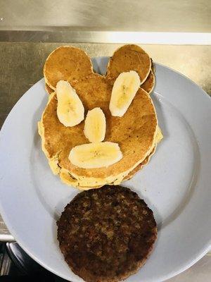 Kids Mickey Mouse pancake with bananas and sausage patty!