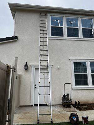 Speedy Animal Control preparing their ladder on our two story home.