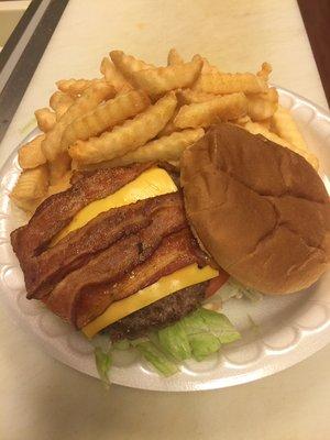 Bacon cheeseburger with lettuce, tomato and mayo. With French fries