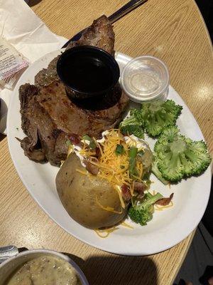 12oz prime rib, veg and loaded baked tater. It also came with a small side salad and cup of soup