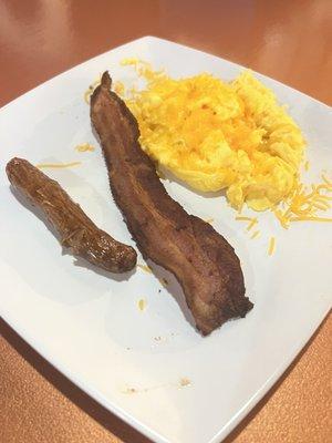 Sausage, bacon, eggs scrambled with cheese.