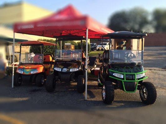 Customized golf carts on display.