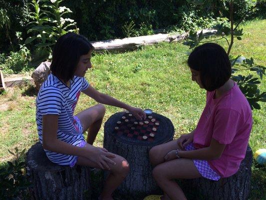 Checkers on tree trunk while u wait