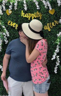 My hubby and I kissing in front of  their "Happily Ever After" backdrop!