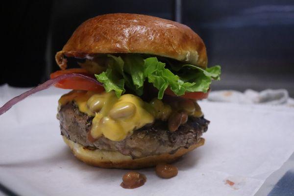 This is our Ranch Burger this is made with a Bison Patty, Baked Beans, American Cheese, Smoked Ketchup, lettuce, Tomato & onion