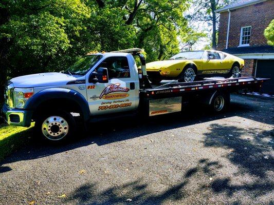 Antique car being towed with a Flatbed Tow Truck from Alexandria Va.