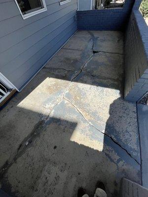 Before photo of my front porch. Once the old paint and bad patching was removed, they had this to work with.