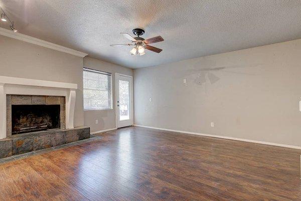 Spacious living room with hardwood floor.