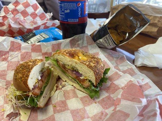 Turkey sandwich on pesto cheese bagel.