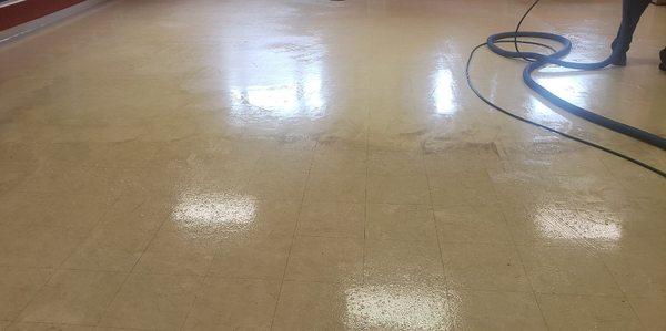 Commercial vinyl floor in the cleaning process.