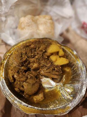 Curry chicken, potatoes, and curry channa under. Roti above the platter. I accidentally bent the aluminum at the bottom of the platter.