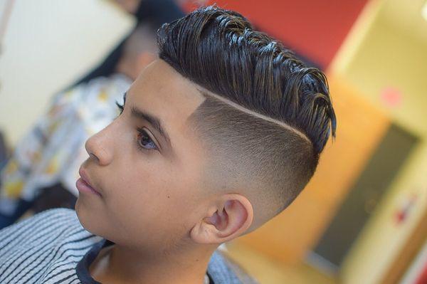 A Kids Haircut with a hard part and combover.