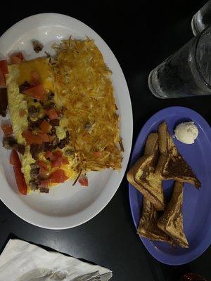 Omelette with bacon sausage tomatoes cheese.