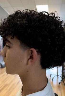 Men's (curly) cut, shaped up the curls with a trim and taper on the side burns