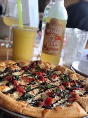 Margaritaville pizza, pineapple slushy and a bottle of wine