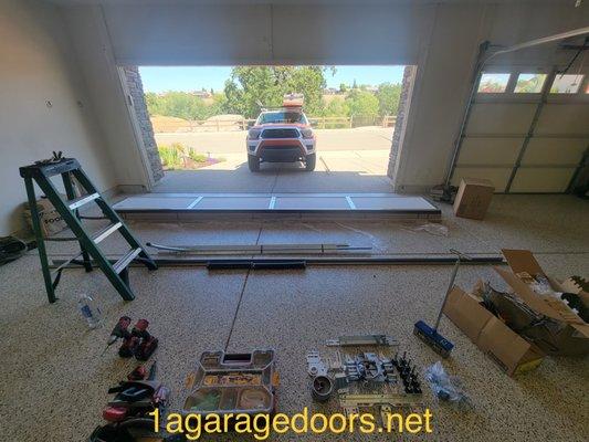 Installing a garage door on one of the properties.