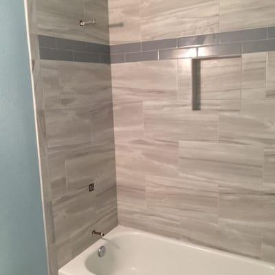 Custom tub/shower surround with a glass subway accent tile. Modern design!