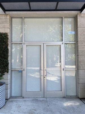 Light filtering roller shades in white.