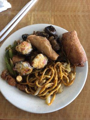 A pile of food from the buffet, including lo mein, egg roll, stuffed mushrooms, crab rangoon, and others.