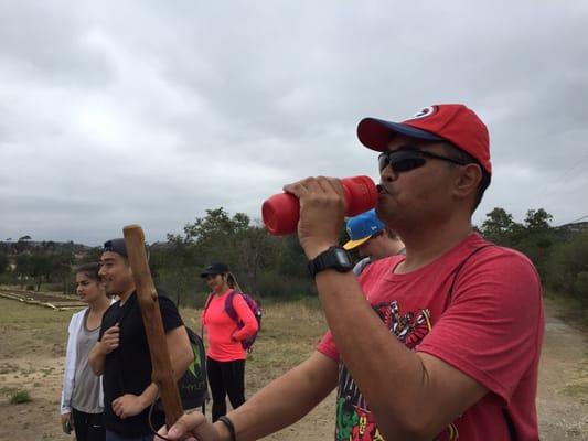 Steve drinking his water and holding his walking stick.