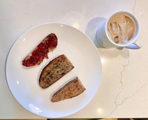 Toasted wheat bread one with jam, one with EVOO and herbs, and one plain