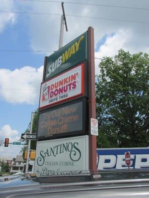 sign in corner showing the businesses that share the parking lot, including Subway