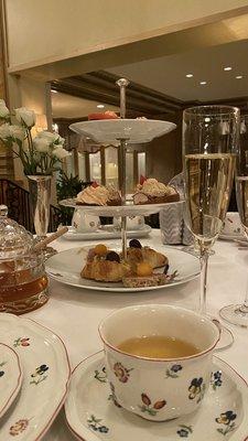 Tea sandwiches, champagne, and white blossom tea