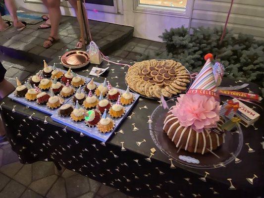 Birthday Bundt cake, and cup cakes with birthday hat toppers.