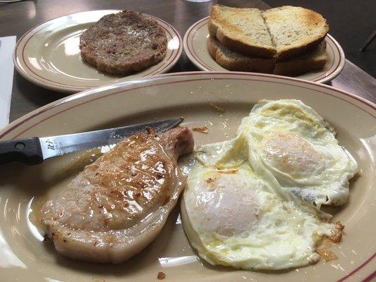 Pork chop with eggs, sausage patty on the side, rye toast. So good.