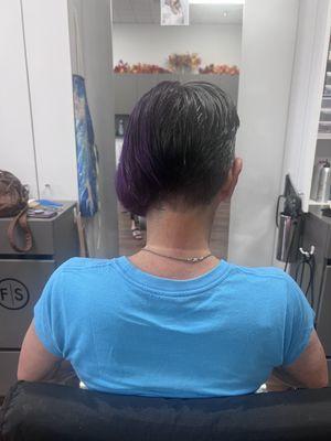 Ladies, you can have funky hair at any age! This asymmetrical cut, and split dye (purple and her natural) was done by Tiffany!