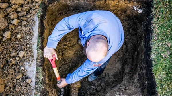 Andy of The Scottish Plumber performing a hand-dug sewer repair.