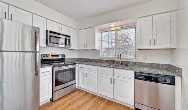 Renovated kitchen with stainless steel appliances and granite countertops