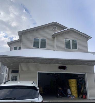 Lake House Remodel: New roof, siding, gutters, porch posts, and decking.