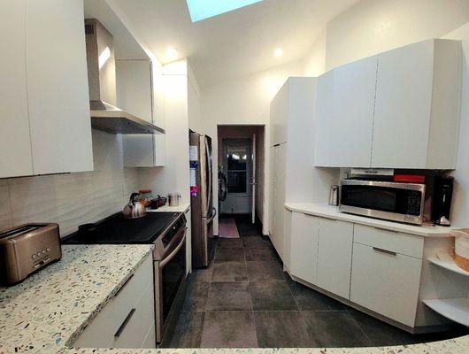 Our new kitchen, looking over sink from the dining room towards the laundry and back door.