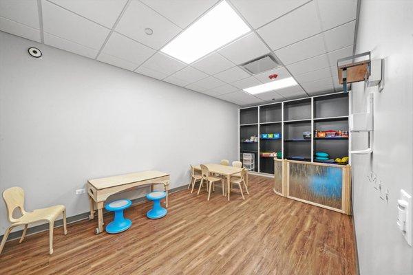 Classroom with child-sized tables and chairs.