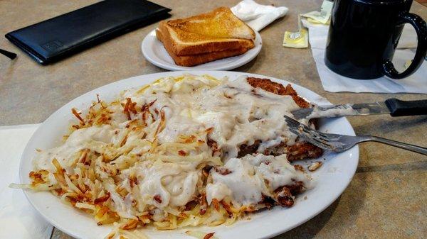 still here breakfast now chicken fried steak and eggs over medium hash browns toast and coffee