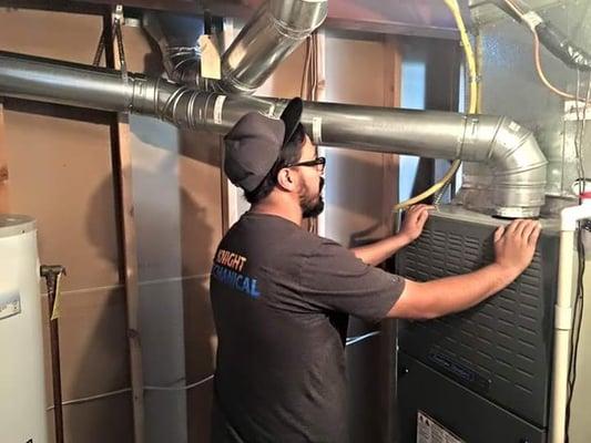 Mr. Aaron performing a quality check on new furnace install