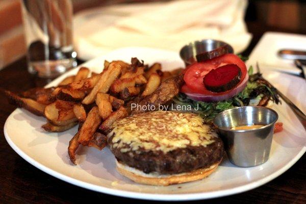 Piedmontese Hamburger with Cheddar ($22) - 8oz. Organic lettuce, tomato, red onion, pickle, dijon aioli, brioche bun. Hand-cut frites.