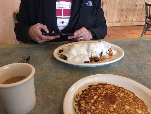 Sierra Blanca - layered sweet biscuits, creamy pepper gravy, chopped breakfast sausage, and fried hash browns.